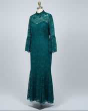 Green lace dress on a mannequin against a white background