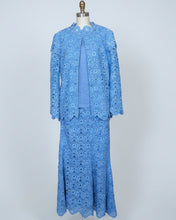Blue lace dress on a mannequin against a white background