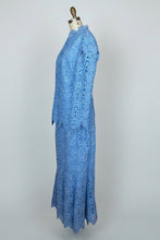 Blue lace dress on a mannequin against a white background