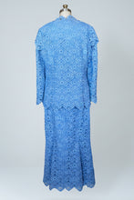 Blue patterned dress on a mannequin against a white background